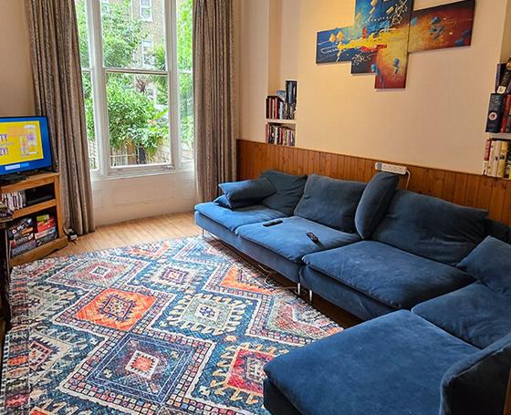 bunk beds in a shared room with green bedding and natural light coming through the window showcasing a cozy living space in a hostel setting
