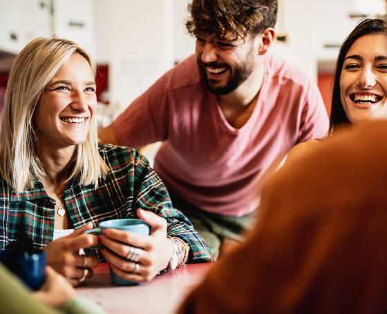 cozy living room with blue couch large window greenery colorful rug bookshelf and television 5 seating arrangements comfort